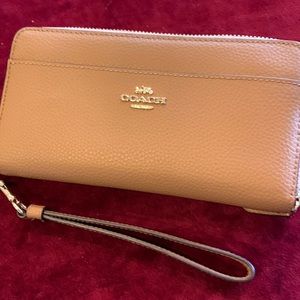 Coach zip around wristlet wallet in Light Saddle.